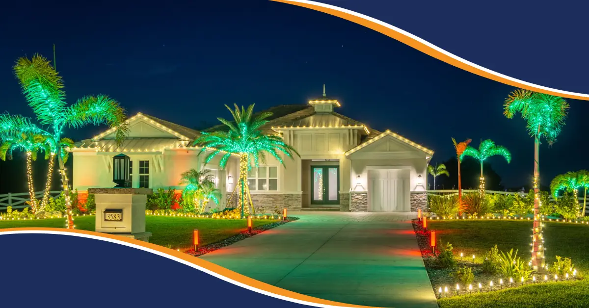 Beautiful Florida home decorated with warm white holiday roofline lights, green illuminated palm trees, and colorful landscape lighting at night.