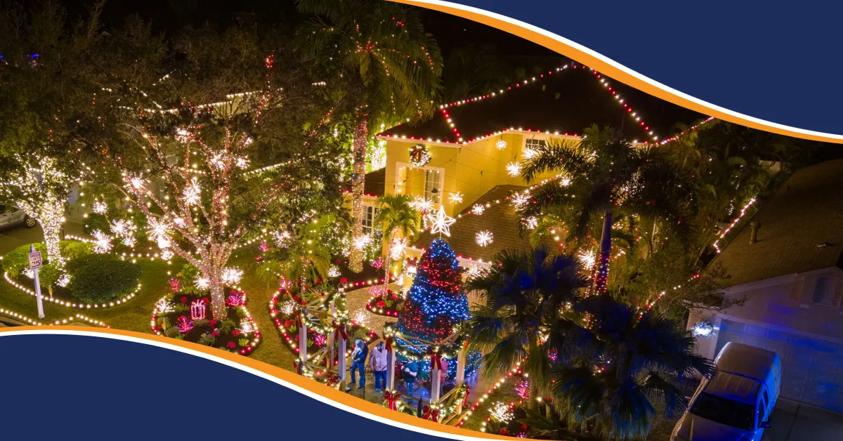 Professionally decorated Sarasota home with Christmas roofline lights, illuminated trees, holiday greenery, and colorful outdoor holiday decorations.